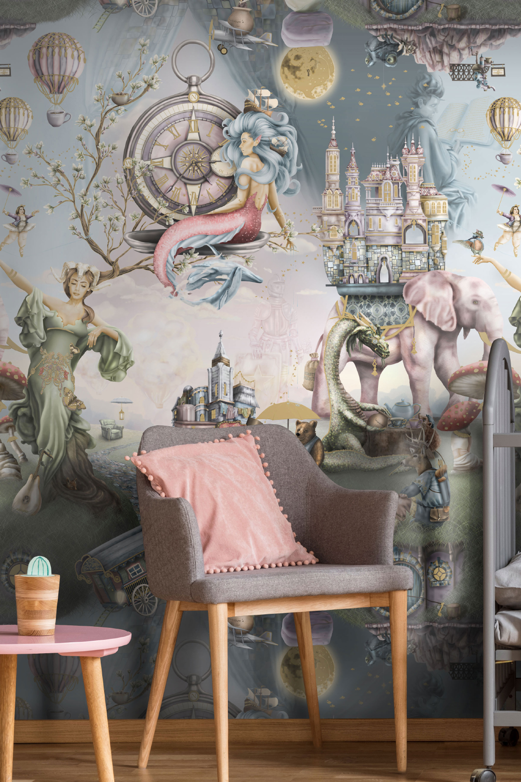 This is luxury designer fairytale wallpaper wall mural design from Australia. It is shown here in a girls bedroom nursery and has been styled with a grey cot, pink side table grey pink and gold wood chair.