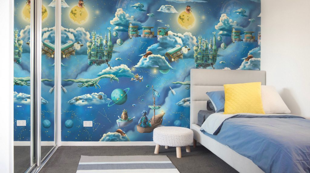 Space and Galaxy Kids Interior Wallpaper Design - featuring a grey blue and white bedroom with custom kids wallpaper. Wallpaper features the moon, night sky, clouds, pirate ships, flying trains, dragon, galaxy and more.