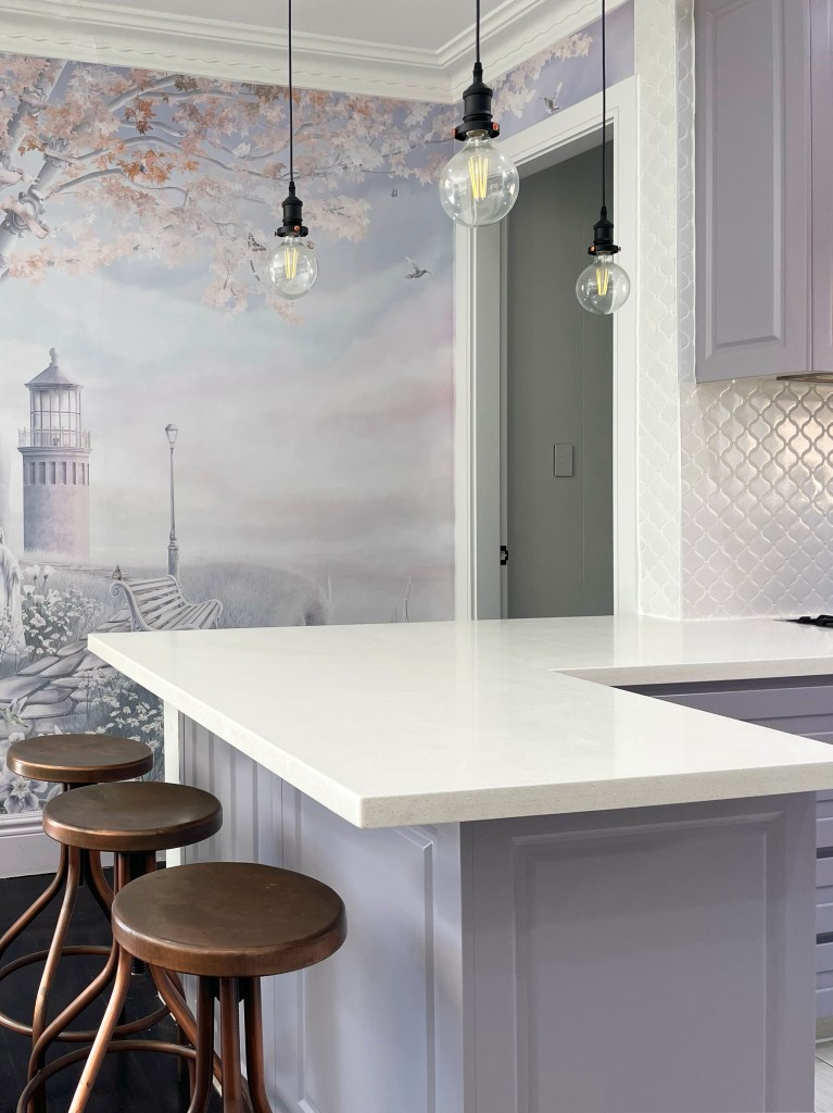 Dusty purple kitchen wallpaper landscape mural, grey kitchen cupboards and white stone 